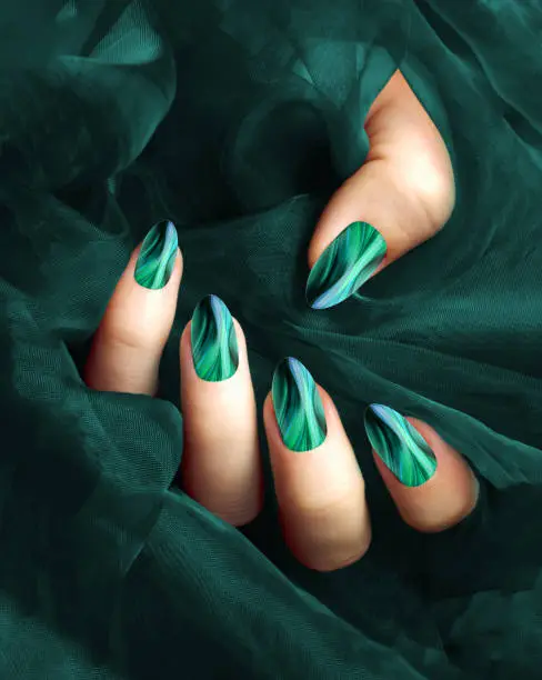 Elegant hand with teal marble nail art